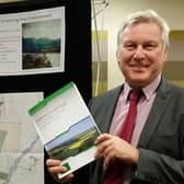 Jim Worley, Melton Council's then head of regulatory services, hold a copy of Melton's draft Local Plan document at a public consultation event back in 2016 EMN-220221-113637001