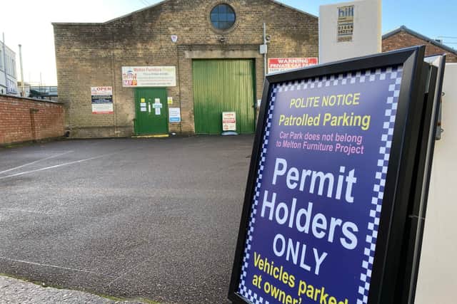 The entrance to Melton and District Furniture Project with the sign advising of the private parking policy EMN-220223-120344001