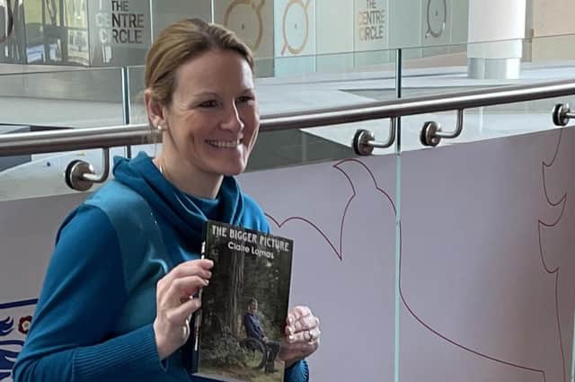 Claire Lomas with a copy of her new book. The Bigger Picture EMN-220803-173222001