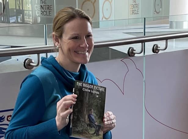 Claire Lomas with a copy of her new book. The Bigger Picture EMN-220803-173222001