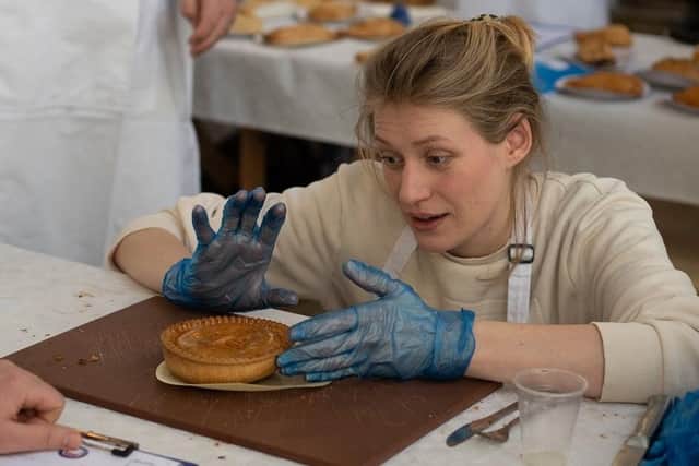 A judge checks out an entry at the British Pie Awards at Melton

PHOTO Martin Elliott - Mepics EMN-220314-131932001