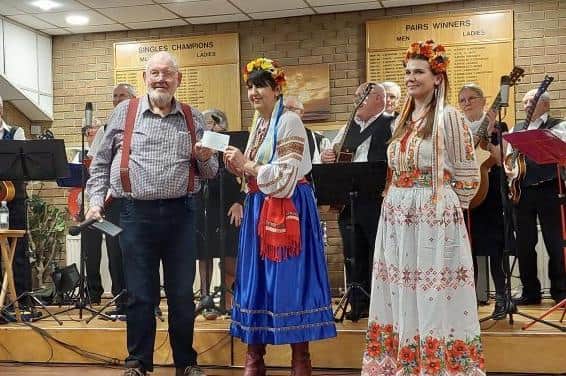 A cheque is handed over by the chair of the Melton and District Indoor Bowls club David Brown to Linda Harris and her daughter in law following a social evening at the club to raise money for the Ukrainian appeal EMN-220318-122136001