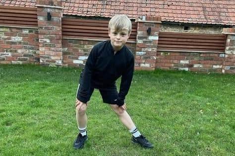 Oscar Smith (10) who is raising money for Ukraine refugees by running the overall distance of a marathon over many different runs EMN-220321-145713001