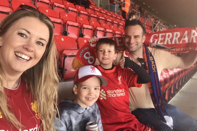 Graham and Kirsty Wells with son, Fletcher and his friend, Austin, pictured at Anfield during their dream trip to see their beloved Liverpool play Barcelona in a legends charity match EMN-220329-124125001