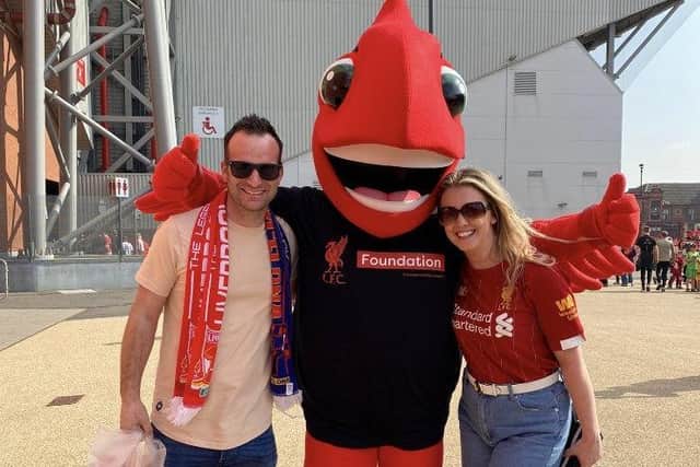 Graham and Kirsty Wells with the Liverpool mascot at the legends charity match at Anfield EMN-220329-124544001