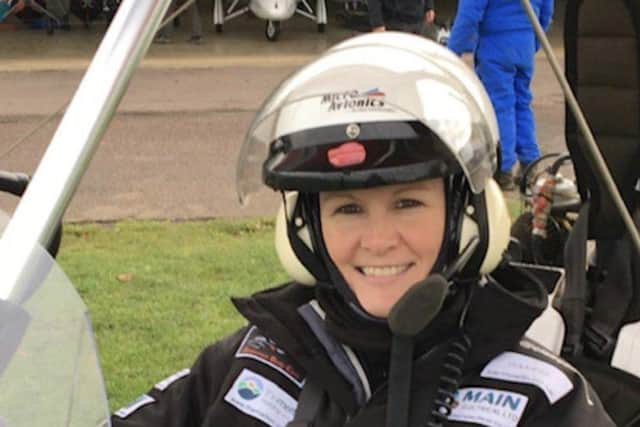 Claire Lomas in a microlight aircraft - she became a qualified pilot in January EMN-220330-110105001