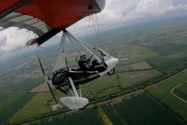 Claire Lomas flying a microlight aircraft - she has launched a raffle with the prize to accompany her on a flight over Melton EMN-220330-110115001
