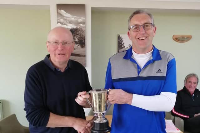 Brendan Byce (left) cellects his trophy from Chris Radford.