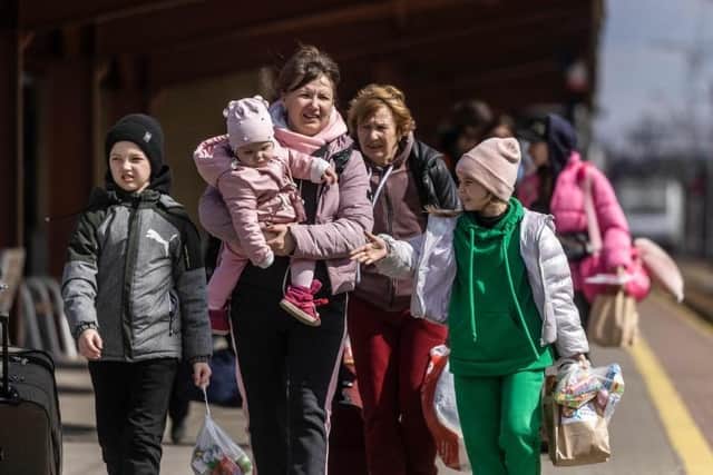 Refugees from Ukraine are seen walking on the platform upon their arrival by train at a railway station in PolandPHOTO Getty Images EMN-220804-163026001
