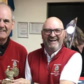 Captain John receives the trophy from Vice-Captain Mike.
