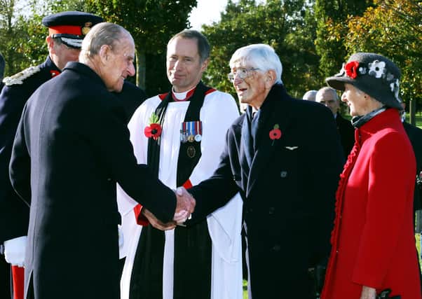 The Duke of Edinburgh greets Dr Sandy Saunders at the unveiling ceremony for a new memorial to the iconic Guinea Pig Club at the National Memorial Arboretum in 2016, watched by Maggie Saunders (right) EMN-210904-170816001