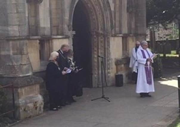 Rev Kevin Ashby take a memorial service for the Duke of Edinburgh outside Melton's St Mary's Church on Sunday morning EMN-210419-095009001