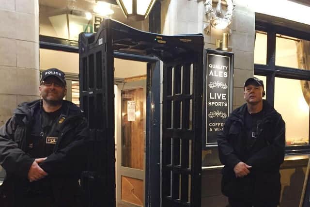 Police officers pictured in 2017 with a knife arch metal-detector outside the Black Swan pub in Melton - it is to be used across Leicestershire again this week as part of a knife crime campaign EMN-210426-134428001
