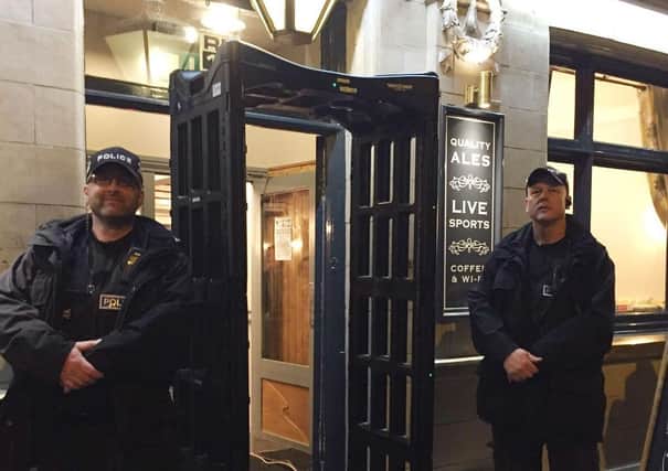 Police officers pictured in 2017 with a knife arch metal-detector outside the Black Swan pub in Melton - it is to be used across Leicestershire again this week as part of a knife crime campaign EMN-210426-134428001