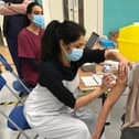 Latham House GP Dr Fahreen Dhanji gives a coronavirus jab to a patient at the vaccination centre at Melton Sports Village EMN-210705-172501001