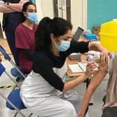 Latham House GP Dr Fahreen Dhanji gives a coronavirus jab to a patient at the vaccination centre at Melton Sports Village EMN-210705-172501001