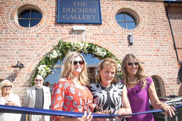 The Duchess of Rutland, flanked by Susannah Constantine (left) and Elizabeth Hurley, cuts the ribbon at the launch of The Engine Yard retail park at Belvoir Castle in September 2018 EMN-211005-160052001