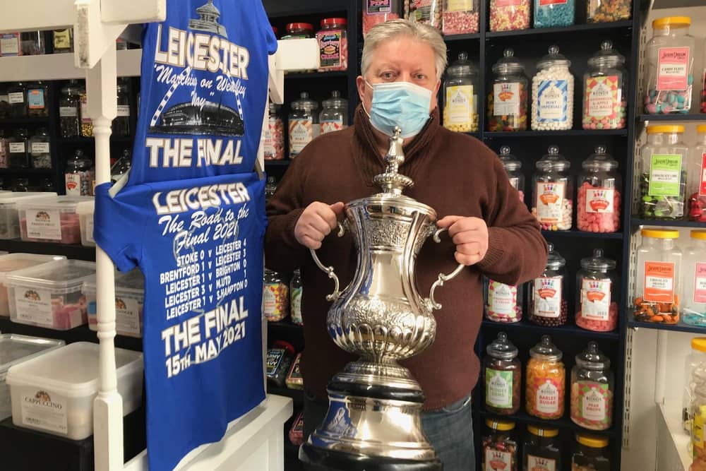 Jamie How, shows off the replica FA Cup trophy he is displaying in the window of his Melton shop, How Sweet EMN-211105-132331001