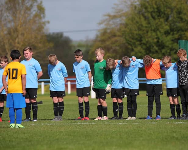 Asfordby's U10 Cobras team and their opponents were among sides to observe a sombre minute's silence on Sunday in memory of first team player Callum Payne, 21, and and young football fan Jordan Banks, who both tragically lost their lives last week. Photo: Phil James