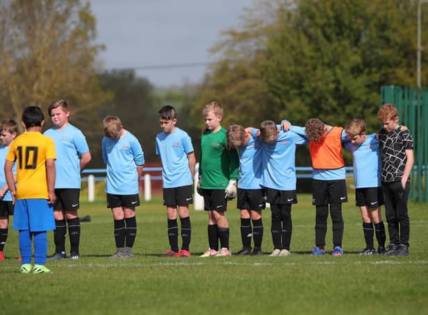 Asfordby's U10 Cobras team and their opponents were among sides to observe a sombre minute's silence on Sunday in memory of first team player Callum Payne, 21, and and young football fan Jordan Banks, who both tragically lost their lives last week. Photo: Phil James