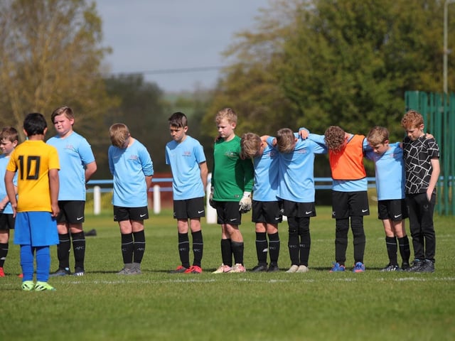 Asfordby's U10 Cobras team and their opponents were among sides to observe a sombre minute's silence on Sunday in memory of first team player Callum Payne, 21, and and young football fan Jordan Banks, who both tragically lost their lives last week. Photo: Phil James