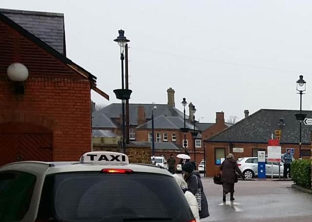 A taxi picks up a fare in the car park at the back of the Bell Centre in Melton EMN-210520-133148001