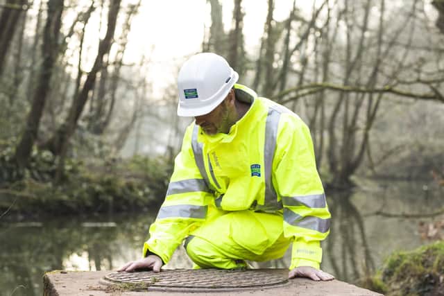 A Severn Trent worker making river checks EMN-210906-142628001