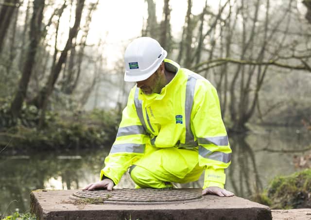 A Severn Trent worker making river checks EMN-210906-142628001