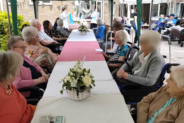 Fellow residents celebrate the diamond wedding of Reg and Julia Brogden at Waltham Hall Nursing Home EMN-210406-125025001