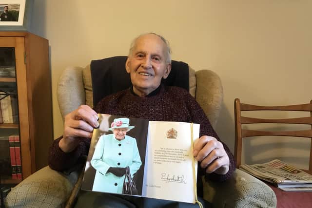 Leslie Posnett, pictured showing off the card he received from The Queen to mark his 100th birthday EMN-210706-174020001