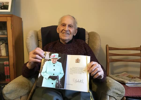 Leslie Posnett, pictured showing off the card he received from The Queen to mark his 100th birthday EMN-210706-174020001