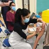 Latham House GP Dr Fahreen Dhanji gives a coronavirus jab to a patient at the vaccination centre at Melton Sports Village EMN-210624-160621001