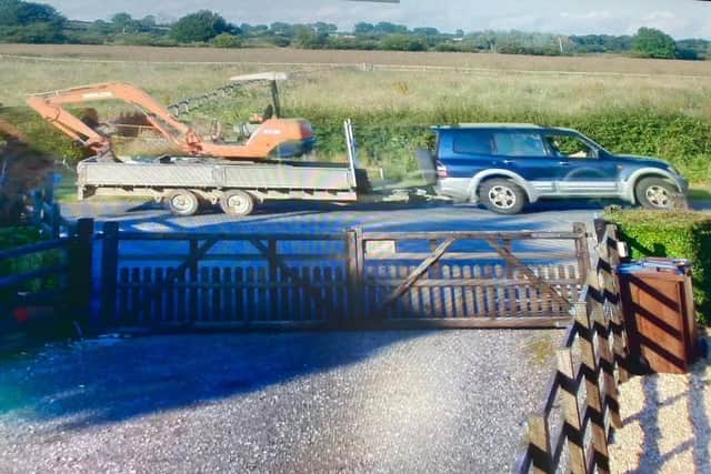 A blue and silver 2004 Mitsubishi Montero sport captured on security cameras towing away a stolen excavator and trailer at Easthorpe EMN-210726-100959001