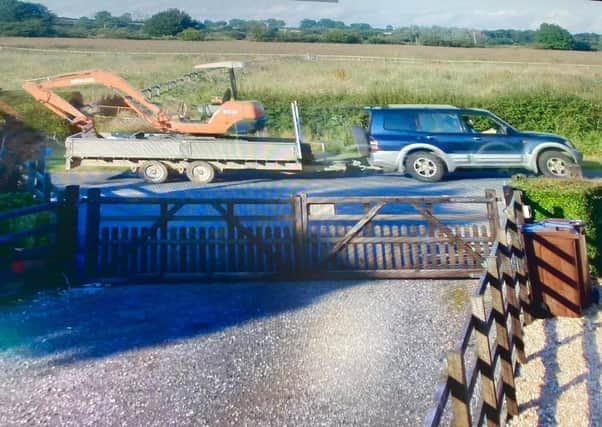 A blue and silver 2004 Mitsubishi Montero sport captured on security cameras towing away a stolen excavator and trailer at Easthorpe EMN-210726-100959001