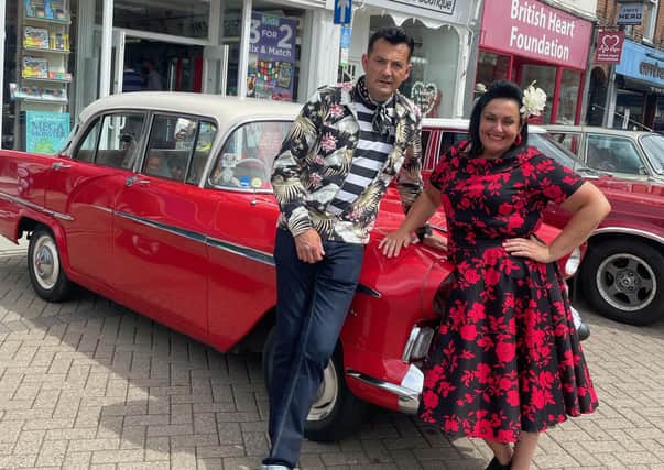 Two attendees at the July monthly vintage and craft market in Melton town centre pose by a classic car at Sunday's event EMN-210729-093309001