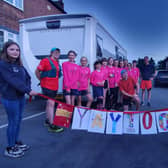 Luke Martino is congratulated by players from Asfordby Amateurs, Ladies Girls & Inclusive FC after completing his 100km run to raise money for a new 3G pitch for training EMN-210308-121254001
