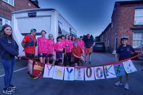 Luke Martino is congratulated by players from Asfordby Amateurs, Ladies Girls & Inclusive FC after completing his 100km run to raise money for a new 3G pitch for training EMN-210308-121254001