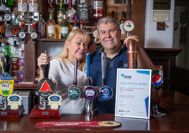 Licensees of The Half Moon pub in Melton Mowbray, Martin Davis and Sandra Shaw, who are celebrating 20 years of running the pub EMN-210508-145415001
