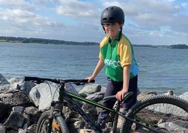 11-year-old Louie Hill pictured during his fundraising cycle around Rutland Water in aid of the NSPCC EMN-210817-174134001