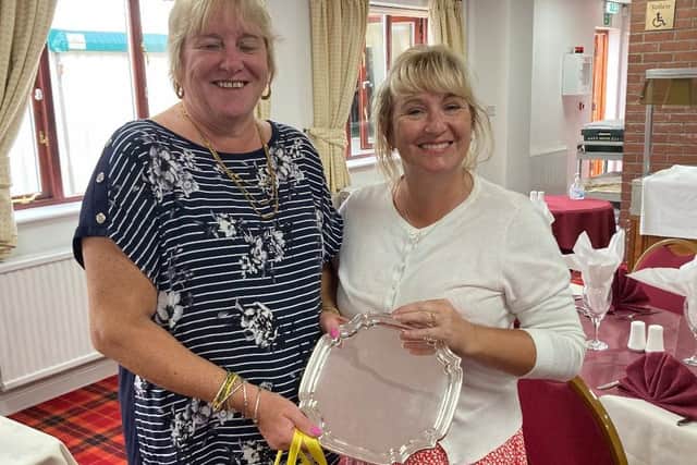 Rachel Jones is seen receiving her trophy from Karen Rawson.