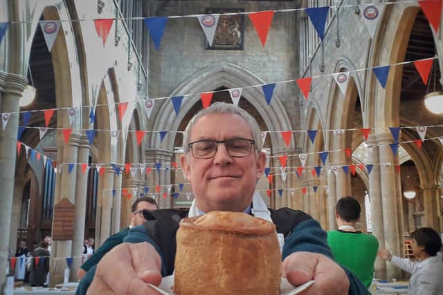Melton rector, the Rev Kevin Ashby, shows off one of the entries for last year's British Pie Awards at St Mary's Church EMN-211009-125452001