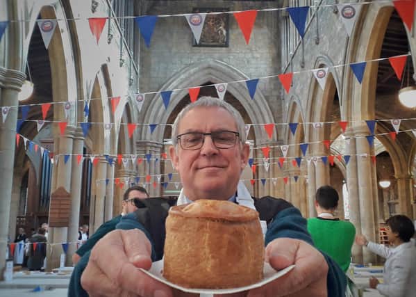 Melton rector, the Rev Kevin Ashby, shows off one of the entries for last year's British Pie Awards at St Mary's Church EMN-211009-125452001