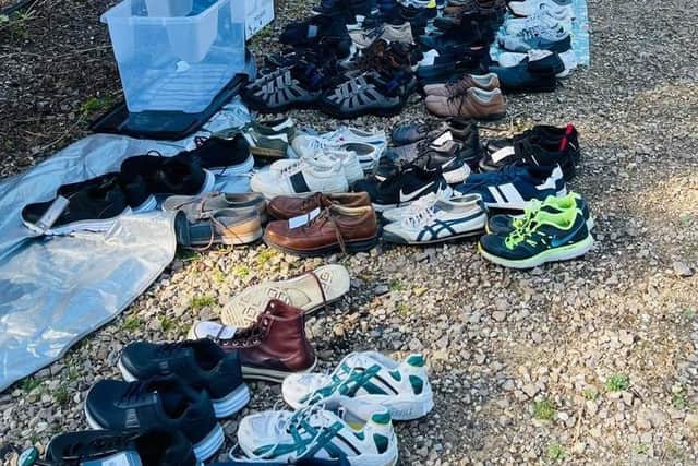 Melton borough councillor Mel Steadman with Karam, from the Care4Calais charity, check out donated trainers during their work with the volunteer collection team EMN-210914-171852001