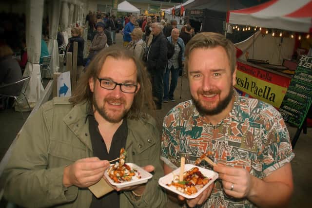 Jeremy Smyth-Osborne and Jamie Russell tuck into some halloumi fries with pomegranate seeds at the East Midlands Food Festival at Melton in 2017 EMN-210928-111049001