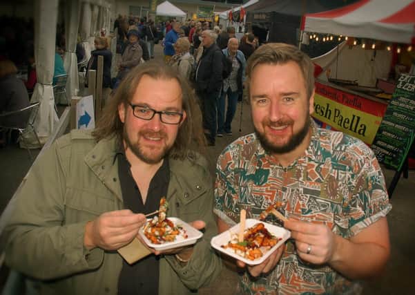 Jeremy Smyth-Osborne and Jamie Russell tuck into some halloumi fries with pomegranate seeds at the East Midlands Food Festival at Melton in 2017 EMN-210928-111049001