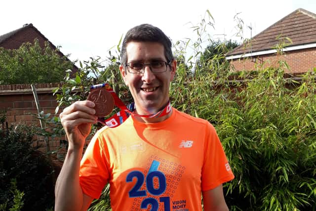 Michael Cooke pictured with his medal after finishing the London Marathon on Sunday where he raised money for the Belvoir Cricket & Countryside Trust EMN-210410-180231001