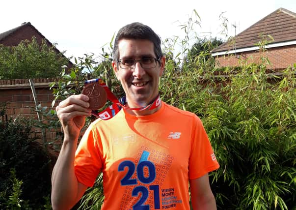 Michael Cooke pictured with his medal after finishing the London Marathon on Sunday where he raised money for the Belvoir Cricket & Countryside Trust EMN-210410-180231001