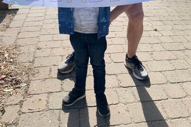 Kieron Clayton gets some encouragement from four-year-old son, Edward, before doing a 'virtual London Marathon' along the canal path from Hickling to Woolsthorpe EMN-210510-132658001