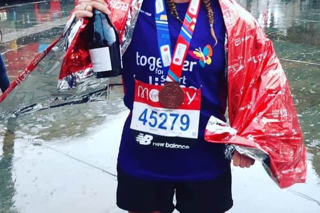 Emma Gardner pictured with her medal and a celebratory bottle of fizz after finishing Sunday's London Marathon EMN-210510-095646001