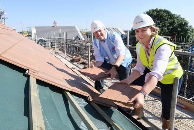 Chris Jones (emh) and Eleanor Deeley (Deeley Group) pictured at the 'topping out' ceremony at The Willows development in Asfordby EMN-210710-155500001